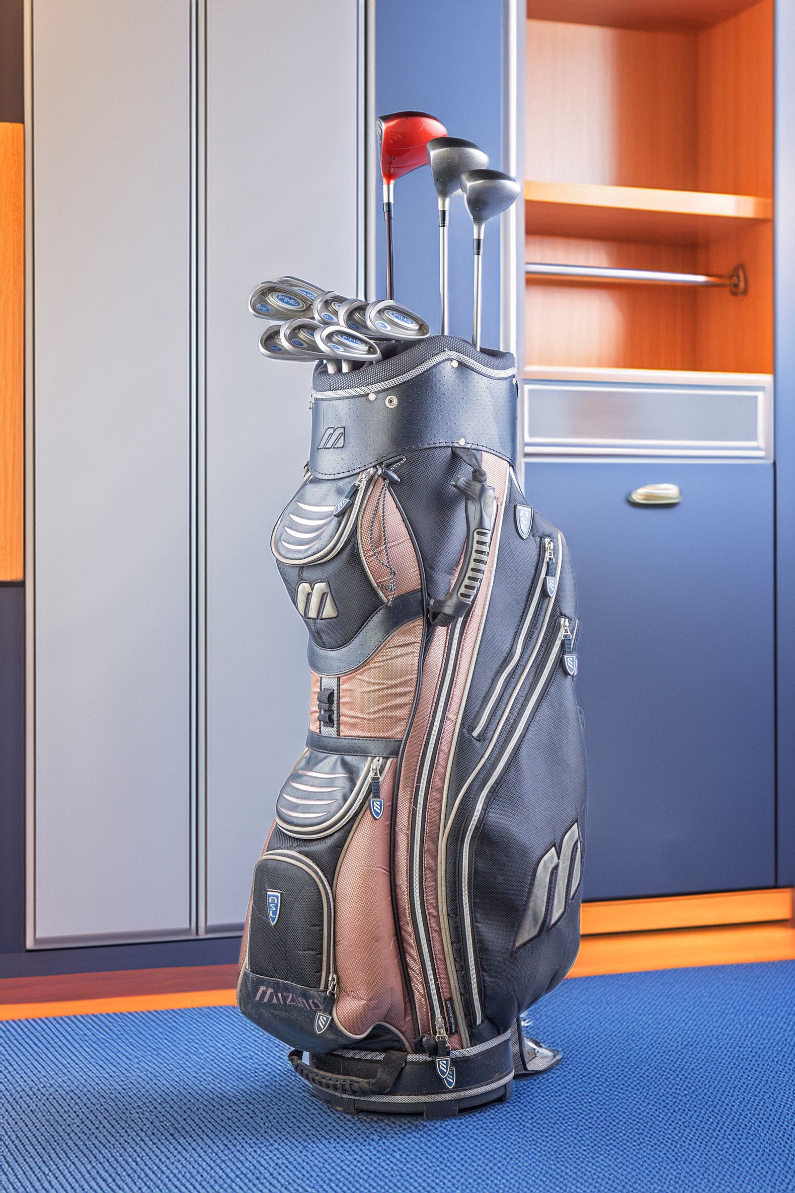 Golf bag with clubs in a clubhouse locker room