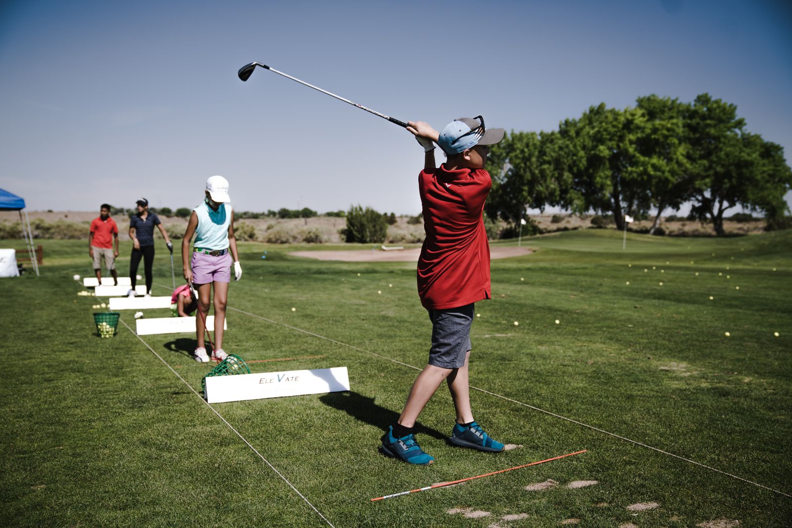 Golfers practicing at a driving range